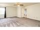 Large bedroom with ceiling fan and view to adjoining bathroom at 108 S Drawbridge Ln, Cary, NC 27513