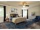 Staged primary bedroom with furniture, artwork, and natural light from the windows at 108 S Drawbridge Ln, Cary, NC 27513