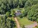 Aerial view of a house on a large lot with mature trees and long private driveway at 109 Mill Creek Dr, Youngsville, NC 27596