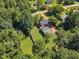 Aerial view displays a property with lush greenery, a fenced backyard, and an outbuilding for extra space at 109 Mill Creek Dr, Youngsville, NC 27596