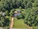 Aerial view showcasing a home with large, wooded lot and long, private driveway at 109 Mill Creek Dr, Youngsville, NC 27596