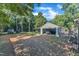 A large backyard with covered parking, truck, and ample green space and trees at 109 Mill Creek Dr, Youngsville, NC 27596