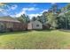 A large backyard has ample green space, surrounded by a wood fence, and large trees at 109 Mill Creek Dr, Youngsville, NC 27596