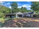 Spacious backyard with trees and a garage and attached carport at 109 Mill Creek Dr, Youngsville, NC 27596