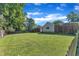 A large backyard has ample green space, surrounded by a wood fence, and large trees at 109 Mill Creek Dr, Youngsville, NC 27596