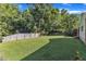 Well-kept backyard with a lush lawn, mature trees, and wooden privacy fence at 109 Mill Creek Dr, Youngsville, NC 27596