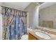 Bathroom featuring a sink and mirror combination, toilet, and shower with colorful curtain at 109 Mill Creek Dr, Youngsville, NC 27596