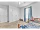 Bedroom with a window with curtains, double closets, ceiling fan, and unmade bed at 109 Mill Creek Dr, Youngsville, NC 27596