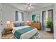 Brightly lit staged bedroom with a ceiling fan, soft rug, natural decor, and neutral paint at 109 Mill Creek Dr, Youngsville, NC 27596