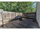 A cozy outdoor deck area with a built-in grill, and rustic wood fence at 109 Mill Creek Dr, Youngsville, NC 27596