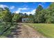 Charming single-story home featuring a well-maintained lawn, gravel driveway, and inviting curb appeal at 109 Mill Creek Dr, Youngsville, NC 27596