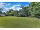 Spacious front lawn highlights this single-story home nestled among mature trees, creating a peaceful setting at 109 Mill Creek Dr, Youngsville, NC 27596