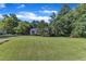 Well-kept home with lush green lawn, mature trees, and traditional architectural details at 109 Mill Creek Dr, Youngsville, NC 27596