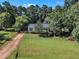 Aerial view of a charming home with a well-manicured lawn and long driveway at 109 Mill Creek Dr, Youngsville, NC 27596