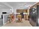 Traditional-style kitchen features wood cabinetry, black appliances, and a breakfast bar at 109 Mill Creek Dr, Youngsville, NC 27596