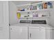 Functional laundry room features shelving for storage and a side-by-side washer and dryer at 109 Mill Creek Dr, Youngsville, NC 27596