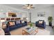 Open-concept living room with stylish furniture and modern decor flows seamlessly into the kitchen at 109 Mill Creek Dr, Youngsville, NC 27596