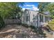 Side view of a single-story home with gravel driveway and private fenced area at 109 Mill Creek Dr, Youngsville, NC 27596