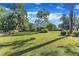 Expansive yard featuring lush lawn, mature trees, and a quaint shed in the background at 109 Mill Creek Dr, Youngsville, NC 27596