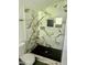 Close up of the glass enclosed shower, black fixtures, and tile accent at 109 N Dunn St, Angier, NC 27501