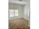 Cozy bedroom with neutral carpet and natural light from windows at 109 N Dunn St, Angier, NC 27501