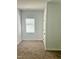 Simple bedroom with a single window and neutral carpet at 109 N Dunn St, Angier, NC 27501