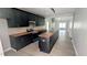 Modern kitchen with dark cabinetry, butcher block countertops, and stainless steel appliances at 109 N Dunn St, Angier, NC 27501