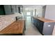 Stylish kitchen featuring dark cabinets, butcher block counters, a center island, and open layout at 109 N Dunn St, Angier, NC 27501