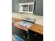 Stainless steel microwave and oven with butcher block counters and tiled backsplash at 109 N Dunn St, Angier, NC 27501