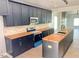 Stylish kitchen with dark cabinets, butcher block countertops, and modern stainless steel appliances at 109 N Dunn St, Angier, NC 27501