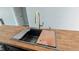Modern black kitchen sink with cutting board and drying rack at 109 N Dunn St, Angier, NC 27501