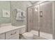 Charming bathroom with beautiful wallpaper, tiled shower, and a sleek glass door at 1204 Sparkling Lake Dr # 20, Apex, NC 27523