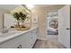 Bright bathroom features dual sinks, white cabinets, and a door leading to the bedroom at 1204 Sparkling Lake Dr # 20, Apex, NC 27523