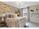 Comfortable bedroom with a large window, accent wall, and neutral decor at 1204 Sparkling Lake Dr # 20, Apex, NC 27523