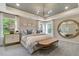 Relaxing bedroom featuring a decorative mirror, plenty of light and an accent wall at 1204 Sparkling Lake Dr # 20, Apex, NC 27523