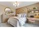 Stylish bedroom with accent wall, decorative mirror, wood dresser and desk with comfortable chair at 1204 Sparkling Lake Dr # 20, Apex, NC 27523