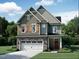 Charming two-story home with a stone-accented garage and well-maintained landscaping at 1204 Sparkling Lake Dr # 20, Apex, NC 27523