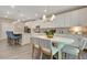 Bright kitchen with stainless steel appliances, white cabinets, and a dining area at 1204 Sparkling Lake Dr # 20, Apex, NC 27523