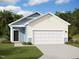 Charming single-Gathering home boasts a two-car garage, blue siding, and a well-manicured lawn at 1209 Solace Way, Rolesville, NC 27571