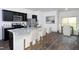 Modern kitchen features stainless steel appliances, granite countertops, and a breakfast bar with seating at 1209 Solace Way, Rolesville, NC 27571