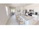 Bright kitchen featuring white cabinets, granite counters, stainless steel appliances, and an island with bar seating at 1209 Solace Way, Rolesville, NC 27571