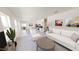 Bright living room with neutral decor, lots of natural light, and open floor plan to kitchen and dining area at 1209 Solace Way, Rolesville, NC 27571