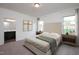 Bright main bedroom with neutral decor, bedside tables, and a view of the backyard at 1209 Solace Way, Rolesville, NC 27571