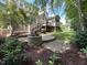 Picturesque backyard showcasing a stone fire pit, a wooden deck and a screened-in porch with a lush lawn at 1316 Plunket Dr, Wake Forest, NC 27587