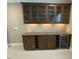 Custom bar area featuring dark wood cabinets, granite countertop and wine refrigerator. Beautiful tile backsplash at 1316 Plunket Dr, Wake Forest, NC 27587