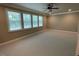 Spacious bedroom with lots of natural light from the multiple windows and a modern ceiling fan at 1316 Plunket Dr, Wake Forest, NC 27587
