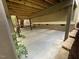 A concrete carport area offering sheltered parking with steps leading to stone-lined mulch beds with green foliage at 1316 Plunket Dr, Wake Forest, NC 27587