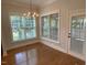 Well-lit dining area featuring hardwood floors, a chandelier, and large windows at 1316 Plunket Dr, Wake Forest, NC 27587