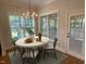 Bright dining area with a round table, chandelier, and large windows at 1316 Plunket Dr, Wake Forest, NC 27587