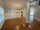 Elegant dining room featuring classic wainscoting, chandelier lighting, and hardwood flooring for sophisticated living at 1316 Plunket Dr, Wake Forest, NC 27587